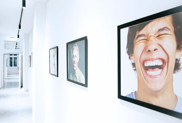 Hallway with photographs of laughing people.