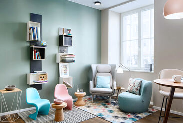 Waiting room with designer furnishings, pastel color tones, and a big picture window.