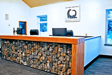 Front desk made of wood on a gabion basket filled with local rocks.